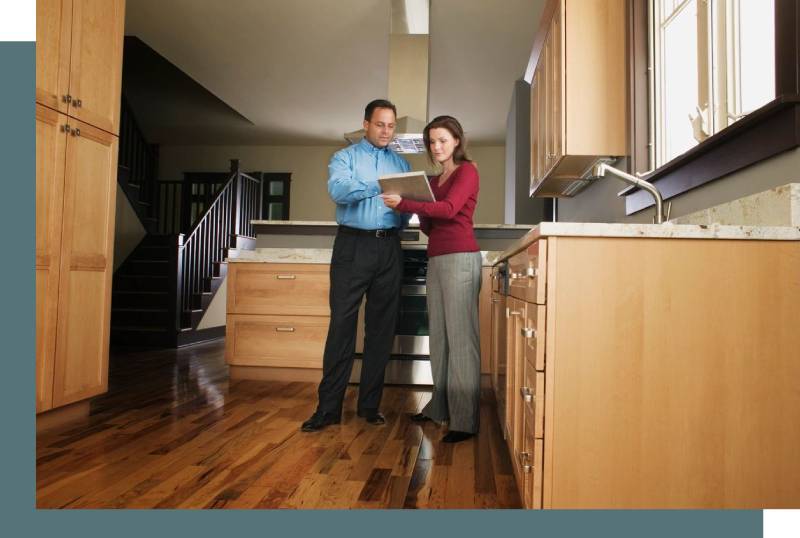 A man and woman standing in the kitchen